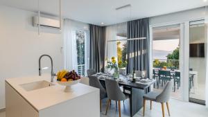 a kitchen and dining room with a table and chairs at VILLA MON AMOUR by Villas Guide in Blato