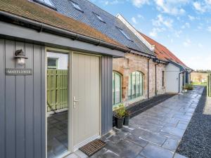 an internal courtyard of a house with a garage at Mayflower - Uk43632 in Grange