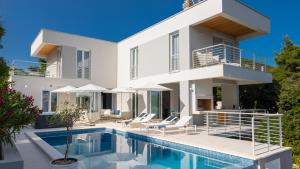 a villa with a swimming pool and a house at VILLA MON AMOUR by Villas Guide in Blato
