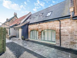 an exterior view of a brick house with windows at Mayflower - Uk43632 in Grange