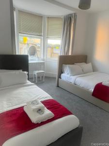 a bedroom with two beds and a window at 12A-2 Stobhill Road in Arniston