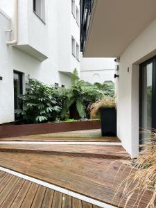 an external view of a building with a wooden deck at City Pop 2Night Paris - Self check-in in Vanves