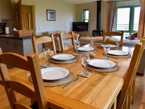 a wooden table with plates and wine glasses on it at Petronella in Grange