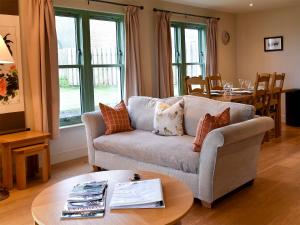 a living room with a couch and a table at Petronella in Grange
