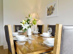 a dining room table with plates and glasses and flowers at Veleta in Grange