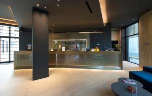 a lobby with a pudica treat counter in a building at Palazzo Loreto Hotel Milano in Milan