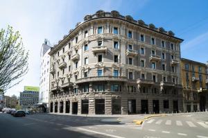 a large stone building on a city street at Palazzo Loreto Hotel Milano in Milan