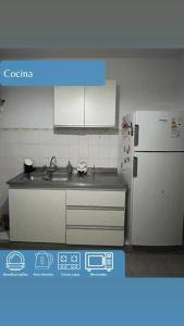 a kitchen with a sink and a refrigerator at Dpto Marce in Chacabuco