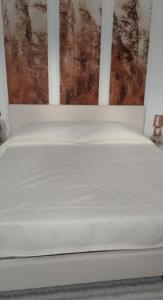 a white bed in a room with a window at Light Loft Marsciano in Marsciano