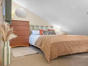 a bedroom with a large bed and a dresser at The Coal House in Skipton +10 photos