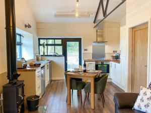a kitchen with a wooden table and a dining room at Serenity- Uk38551 in Endon