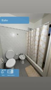 a bathroom with a toilet and a sink and a shower at Dpto Marce in Chacabuco