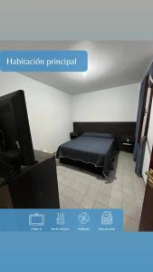 a bedroom with a bed and a television at Dpto Marce in Chacabuco