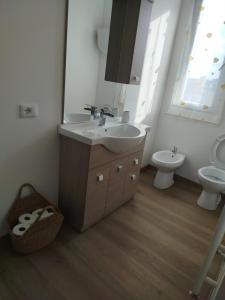a bathroom with a sink and a toilet at Light Loft Marsciano in Marsciano +6 photos