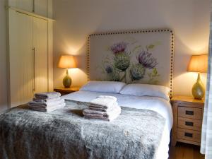 a bedroom with a bed with towels on it at Strathspey in Grange