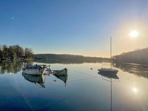 two boats sitting in the water on a lake at Oystercatcher Cottage in Haverfordwest