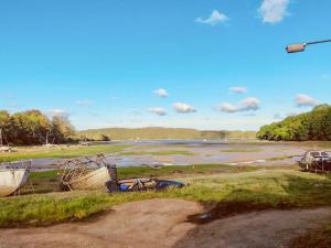 a view of a river with boats in a field at Oystercatcher Cottage in Haverfordwest