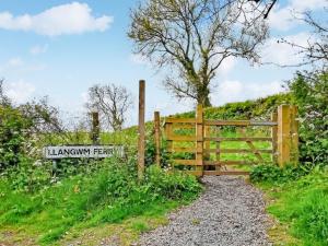 a gate to a field with a sign at Oystercatcher Cottage in Haverfordwest +27 photos