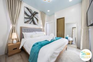 a bedroom with a large bed and a mirror at Haven's Villa in Agus +48 photos