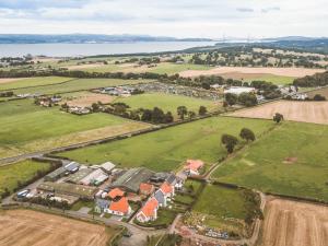 an aerial view of a village with a field and water at Speed The Plough- Uk43631 in Grange