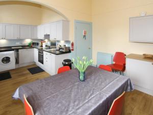 a kitchen with a table with a vase of flowers on it at The Townhouse in Inverness
