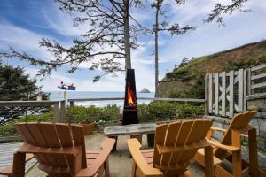 a table and chairs sitting on a patio with the beach at Ocean's Edge in Tillamook