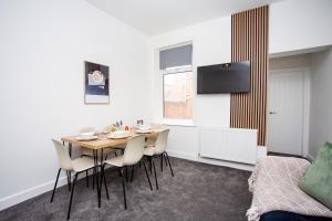 a dining room with a table and chairs at Vacant Nests The Ropery 4BR Seafront in Seaham