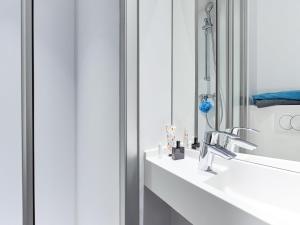 a bathroom with a sink and a mirror at hotelF1 Crosne Créteil in Crosne +59 photos