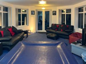 a living room with a couch and a tv at Haven In The Burn in Newburn