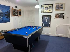 a billiard room with a pool table and framed pictures at Haven In The Burn in Newburn