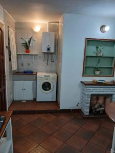 a kitchen with a washing machine and a fireplace at Rincon bonito in Salta