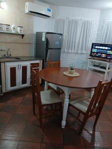 a kitchen with a table and chairs and a refrigerator at Rincon bonito in Salta