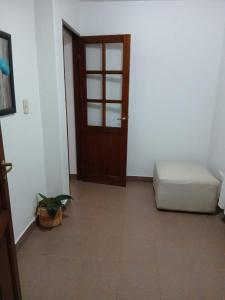 a room with a door and a couch and a plant at Rincon bonito in Salta