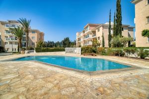 a swimming pool in the middle of a building at Elysia Park Star in Paphos