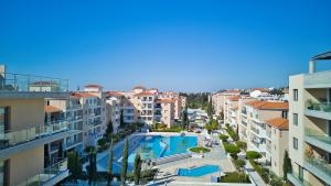 arial view of a city with a swimming pool and buildings at Elysia Park Star in Paphos