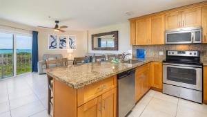 a kitchen with wooden cabinets and a counter top at Coastal Joy 3412 Ocean Pointe in Tavernier +43 photos