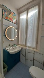 a bathroom with a sink and a mirror and a toilet at Casa Braglia in Modena