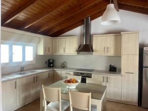 a kitchen with a table with a bowl of fruit on it at Hera Loft in Ireon