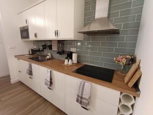 a kitchen with white cabinets and a sink at Apartamento El Topo in Los Sauces