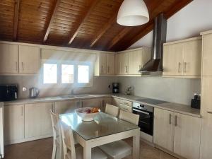 a kitchen with a table with a bowl of fruit on it at Hera Loft in Ireon +8 photos