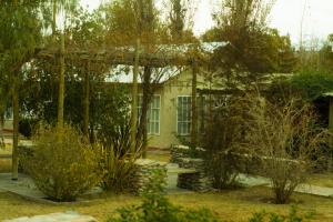 a garden with a pavilion in front of a house at Hotel de Campo Calingasta in Calingasta