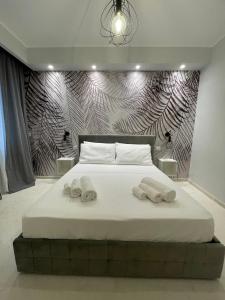 a bedroom with a bed with two towels on it at Suite 55 in Trani +6 photos