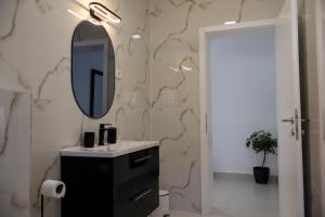 a bathroom with a sink and a mirror at Velebit Escape Apartments in Starigrad +48 photos