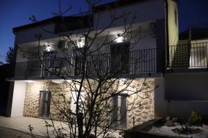 a building with lights on the side of it at Velebit Escape Apartments in Starigrad
