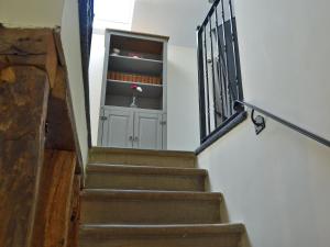 a stairway with a cabinet with a flower in it at The Old Stables in Bakewell