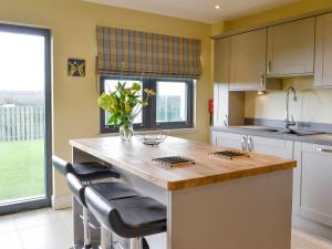 a kitchen with a large island with a counter top at The Haymakers in Grange