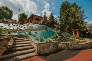 a swimming pool at a resort with stairs at ANTON Tenczyn in Tenczyn