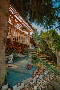 a house with a wooden roof and a walkway at ANTON Tenczyn in Tenczyn