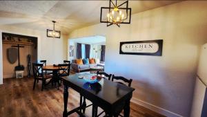 a dining room and living room with a table and chairs at Ambervine in Lowell