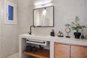 a bathroom with a sink and a mirror at Kyma in Kardhianí +44 photos